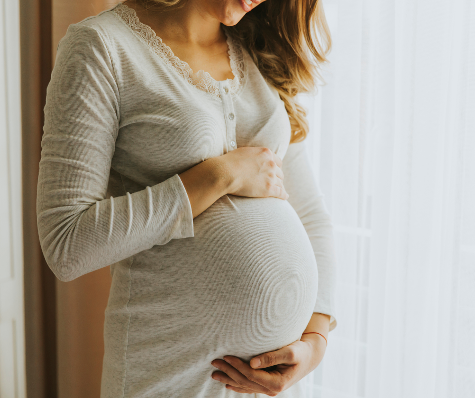 A pregnant woman cradling her belly